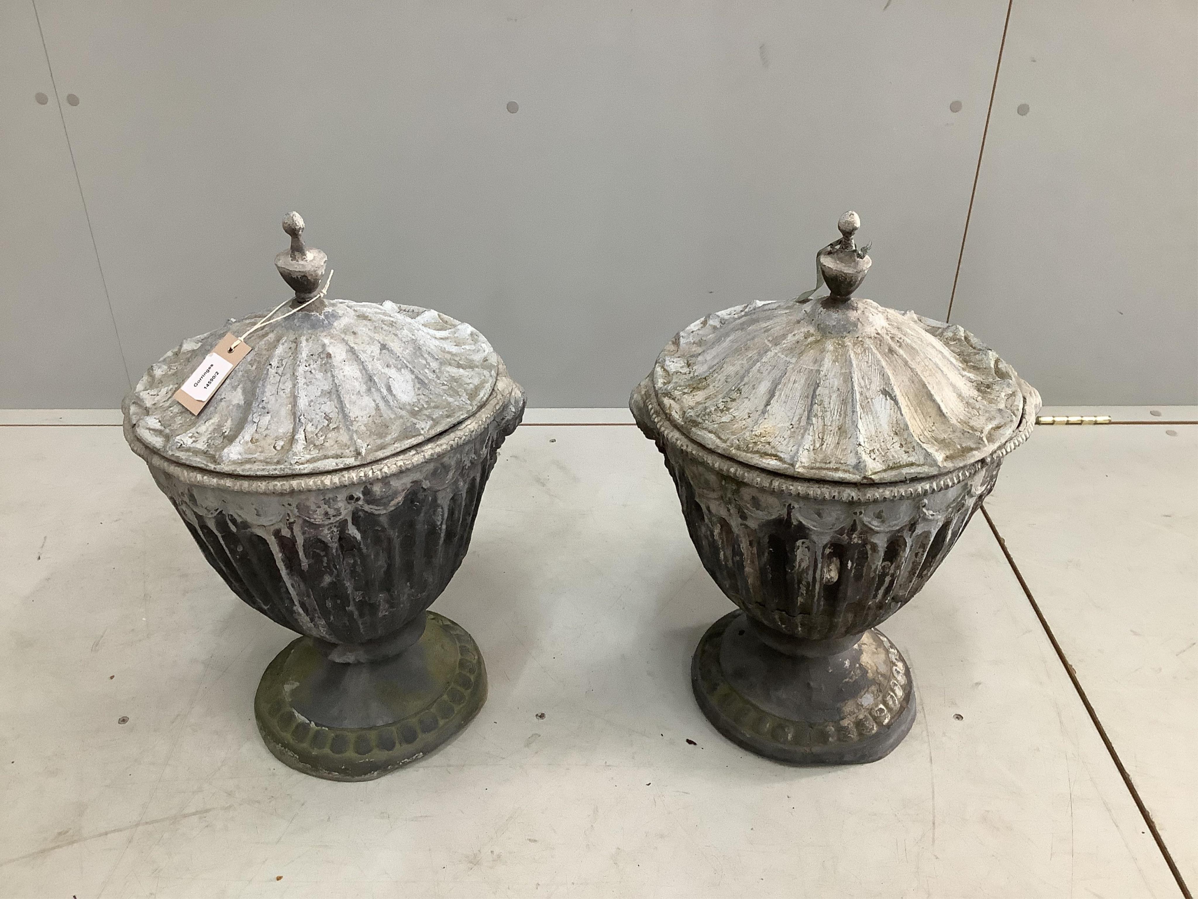 A pair of 19th century lead urns and covers, height 52cm. Condition - fair